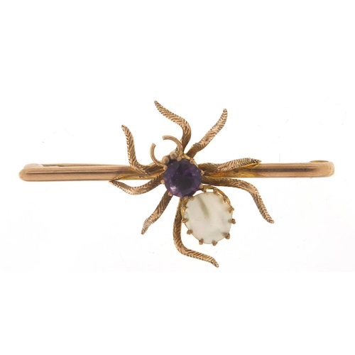 214 - Unmarked gold spider bar brooch set with amethyst and mother of pearl, 5cm wide, 5.5g