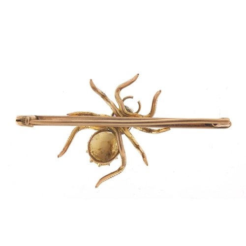 214 - Unmarked gold spider bar brooch set with amethyst and mother of pearl, 5cm wide, 5.5g