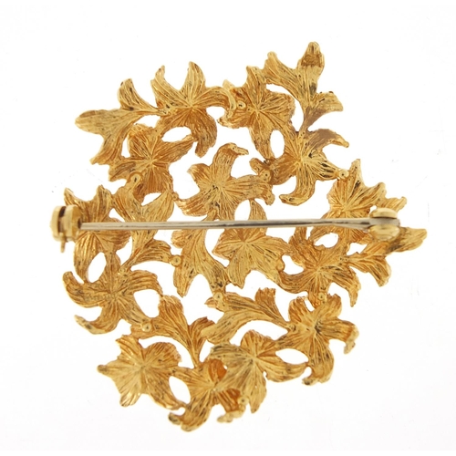 74 - Unmarked gold floral brooch, (tests as 15ct+ gold) 4cm high, 10.8g