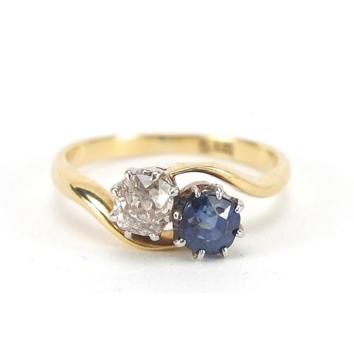 343 - 18ct gold diamond and sapphire crossover ring, the diamond approximately 4mm in diameter, size K, 3.... 