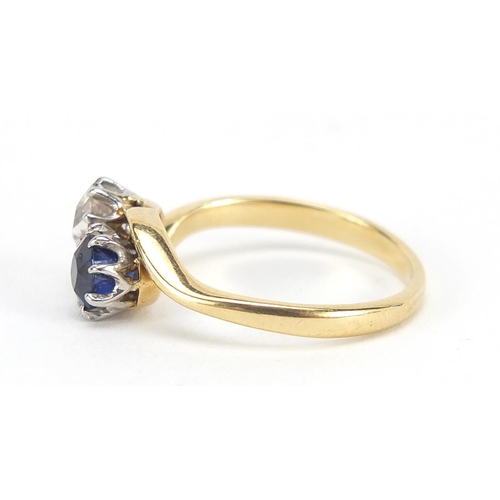 343 - 18ct gold diamond and sapphire crossover ring, the diamond approximately 4mm in diameter, size K, 3.... 