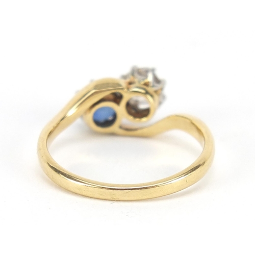 343 - 18ct gold diamond and sapphire crossover ring, the diamond approximately 4mm in diameter, size K, 3.... 