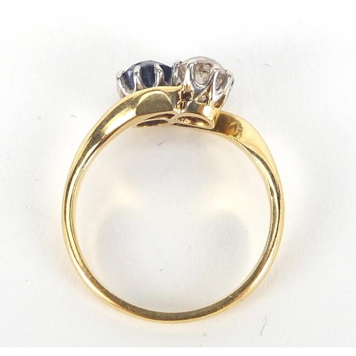 343 - 18ct gold diamond and sapphire crossover ring, the diamond approximately 4mm in diameter, size K, 3.... 