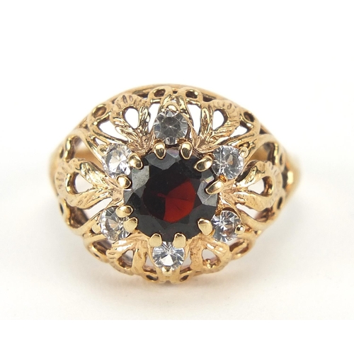 213 - 9ct gold garnet and white sapphire ring with pierced setting, size N, 4.0g