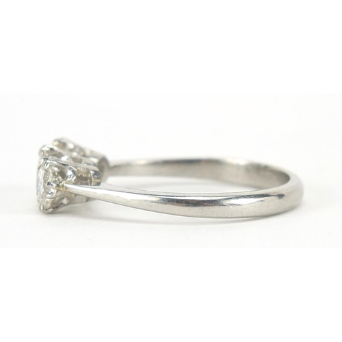 73 - White gold diamond three stone ring, the central diamond approximately 4.5mm in diameter, indistinct... 