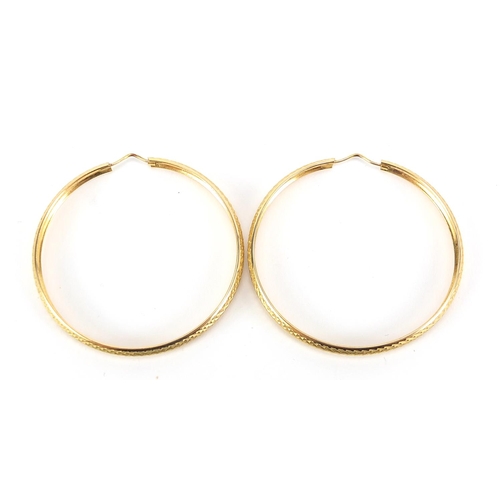 196 - Pair of large 9ct gold hoop earrings with engine turned decoration, 5.2cm in diameter, 8.4g