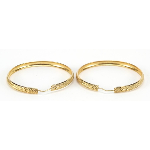 196 - Pair of large 9ct gold hoop earrings with engine turned decoration, 5.2cm in diameter, 8.4g