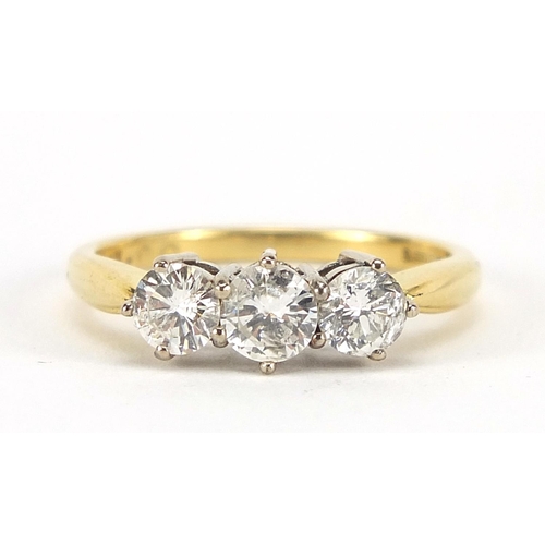27 - 18ct gold diamond three stone ring, the central diamond approximately 4.2mm in diameter, size O, 3.4... 
