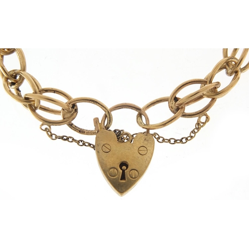 355 - 9ct gold charm bracelet with love heart padlock, 20cm in length, 24.0g