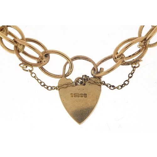 355 - 9ct gold charm bracelet with love heart padlock, 20cm in length, 24.0g