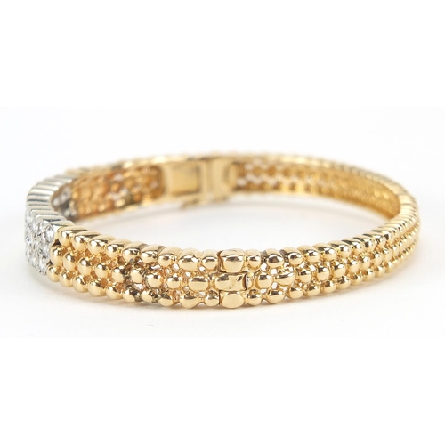 109 - 14ct gold diamond three row hinged bangle, set wit thirty three diamonds, the diamonds approximately... 