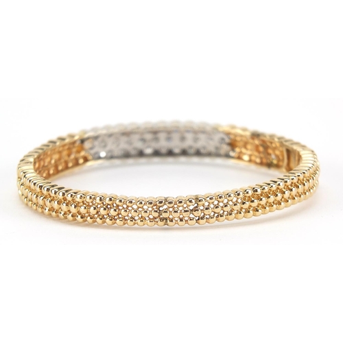 109 - 14ct gold diamond three row hinged bangle, set wit thirty three diamonds, the diamonds approximately... 