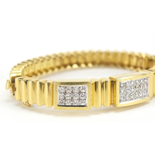 33 - 18ct gold diamond cluster hinged bangle, set with forty two diamonds the diamonds approximately 2.2m... 