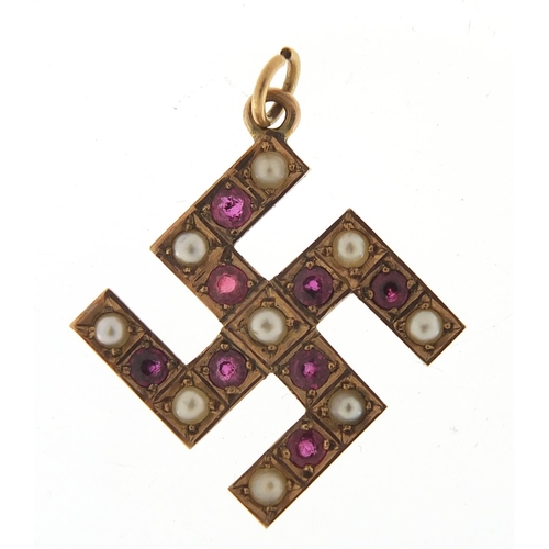 251 - 9ct gold ruby and pearl swastika pendant, 3cm high, 3.0g