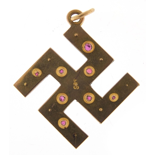 251 - 9ct gold ruby and pearl swastika pendant, 3cm high, 3.0g