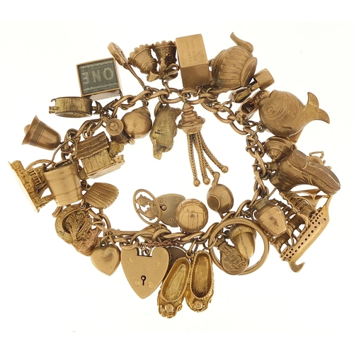 174 - Good 9ct gold charm bracelet with a large selection of mostly gold charms including a rigged sailing... 