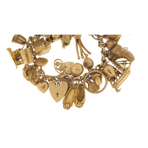 174 - Good 9ct gold charm bracelet with a large selection of mostly gold charms including a rigged sailing... 