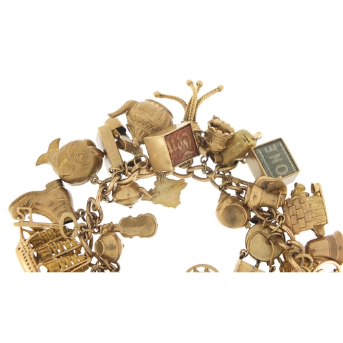 174 - Good 9ct gold charm bracelet with a large selection of mostly gold charms including a rigged sailing... 