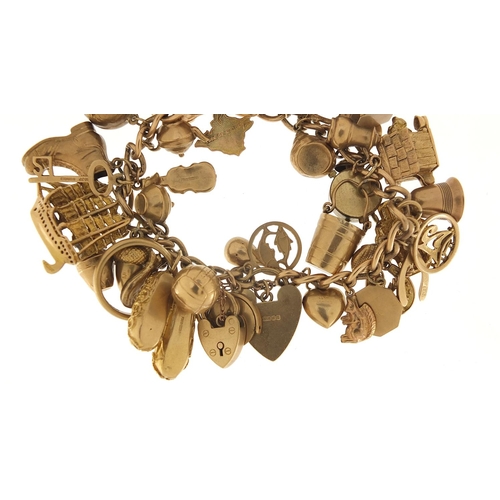 174 - Good 9ct gold charm bracelet with a large selection of mostly gold charms including a rigged sailing... 