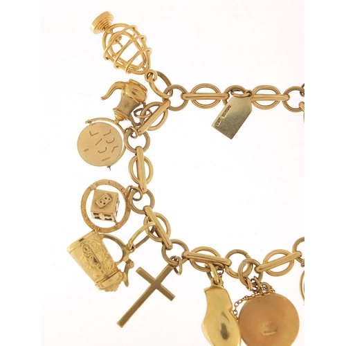 40 - 9ct gold charm bracelet with a selection of mostly gold charms including St Christopher, Dutch clog ... 