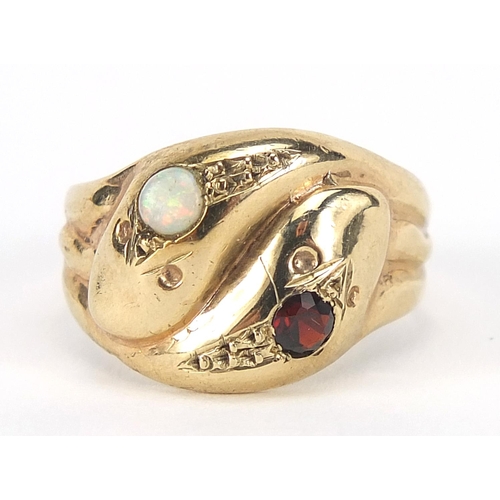 195 - 9ct gold serpent ring set with a garnet and opal, size Q, 4.2g