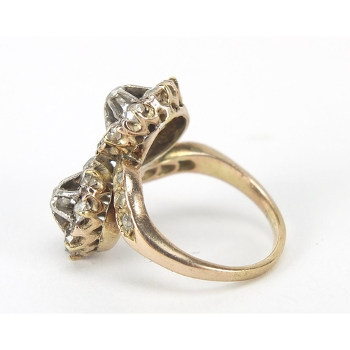 347 - Antique unmarked gold diamond cluster crossover ring, the larger diamonds approximately 2.8mm in dia... 