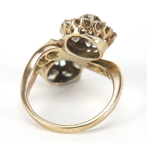 347 - Antique unmarked gold diamond cluster crossover ring, the larger diamonds approximately 2.8mm in dia... 