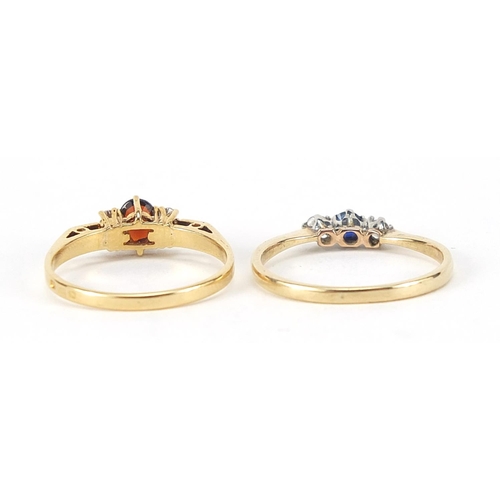 239 - Two unmarked gold rings set with diamonds, sapphire and garnet, sizes L and N, total 3.7g