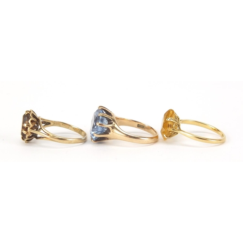 224 - Three gold rings comprising 18ct gold with citrine and two 9ct gold, sizes J, K and L, total 9.4g