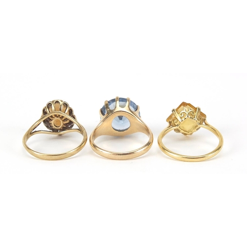 224 - Three gold rings comprising 18ct gold with citrine and two 9ct gold, sizes J, K and L, total 9.4g