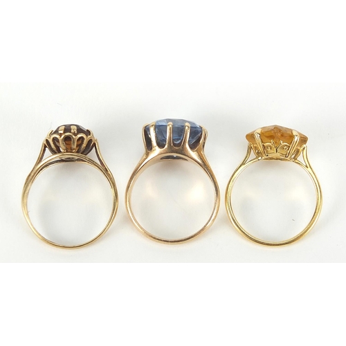 224 - Three gold rings comprising 18ct gold with citrine and two 9ct gold, sizes J, K and L, total 9.4g