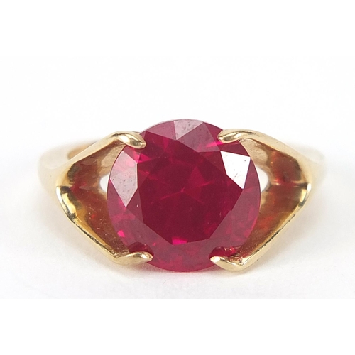 62 - Unmarked gold ruby solitaire ring, the stone approximately 10mm in diameter, size J, 3.6g