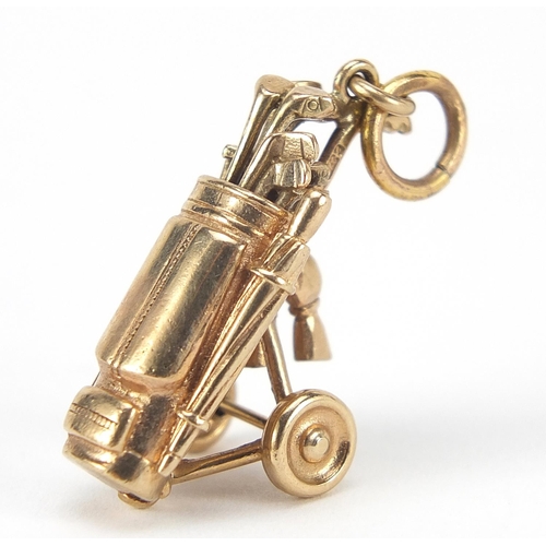 134 - 9ct gold golf club and caddy charm, 3cm high, 6.5g