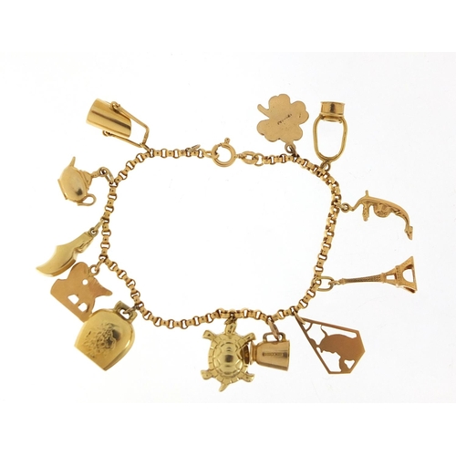 249 - 18ct gold charm bracelet with a selection of 9ct and 18ct gold charms including Eiffel Tower, tortoi... 