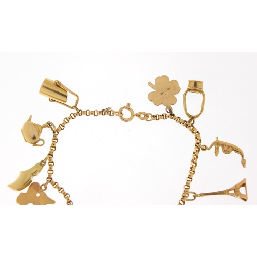 249 - 18ct gold charm bracelet with a selection of 9ct and 18ct gold charms including Eiffel Tower, tortoi... 