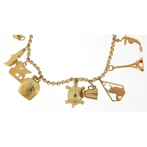 249 - 18ct gold charm bracelet with a selection of 9ct and 18ct gold charms including Eiffel Tower, tortoi... 