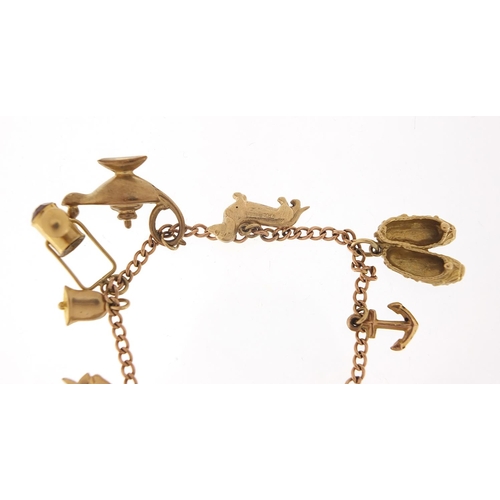 123 - 9ct gold charm bracelet with a selection of mostly 9ct gold charms including Genie oil lamp, skiing ... 