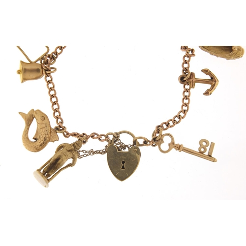 123 - 9ct gold charm bracelet with a selection of mostly 9ct gold charms including Genie oil lamp, skiing ... 