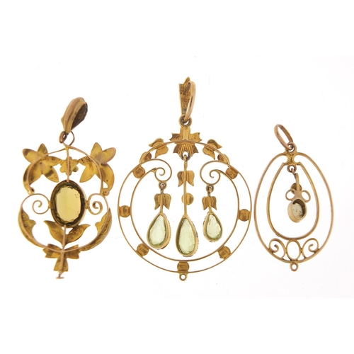 153 - Three Art Nouveau gold pendants set with peridot, seed pearls and opal, the largest 4.4cm high, tota... 