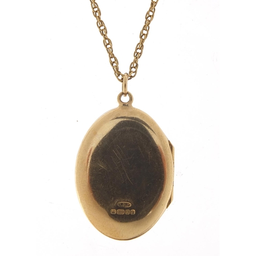 127 - Oval 9ct gold locket with engraved decoration on a 9ct gold necklace, 3cm high and 60cm in length, t... 