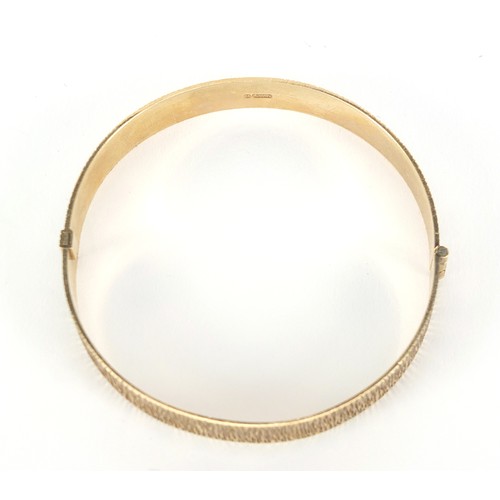 348 - 9ct gold bark design hinged bangle, 6cm in diameter, 19.0g