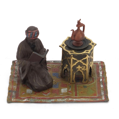 2455 - Cold painted bronze figure of an Arab on a carpet in the style of Franz Xaver Bergmann, 14cm wide