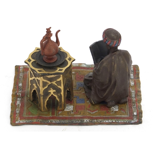 2455 - Cold painted bronze figure of an Arab on a carpet in the style of Franz Xaver Bergmann, 14cm wide