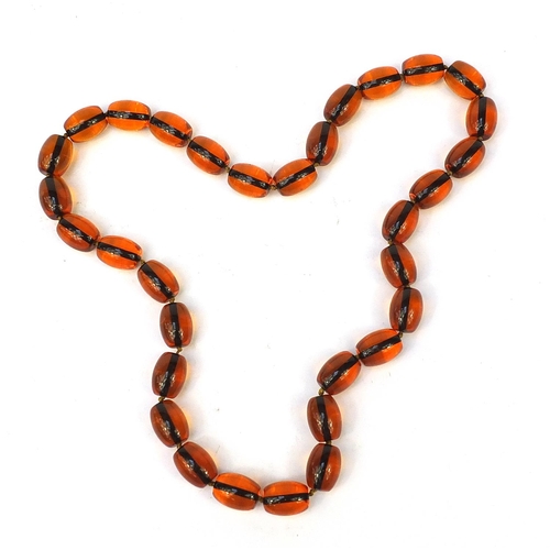 2810 - Amber coloured bead necklace, 84cm in length, 202.5g