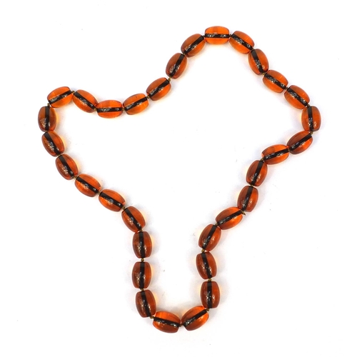 2810 - Amber coloured bead necklace, 84cm in length, 202.5g