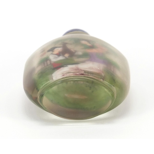 2436 - Chinese glass snuff bottle with hardstone stopper, internally hand painted with females, 10.5cm high