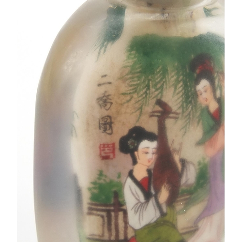 2436 - Chinese glass snuff bottle with hardstone stopper, internally hand painted with females, 10.5cm high