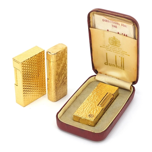 506 - Three vintage gold plated pocket lighters comprising Dunhill with fitted case, S J Dupont and Magie ... 