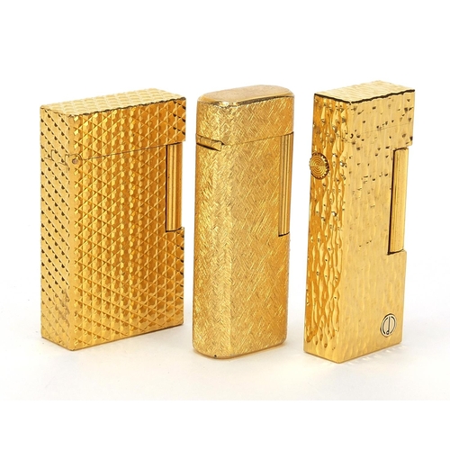 506 - Three vintage gold plated pocket lighters comprising Dunhill with fitted case, S J Dupont and Magie ... 