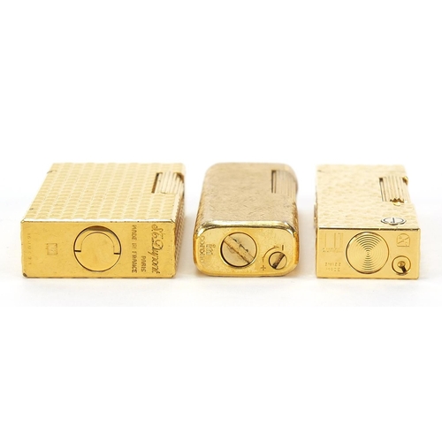 506 - Three vintage gold plated pocket lighters comprising Dunhill with fitted case, S J Dupont and Magie ... 